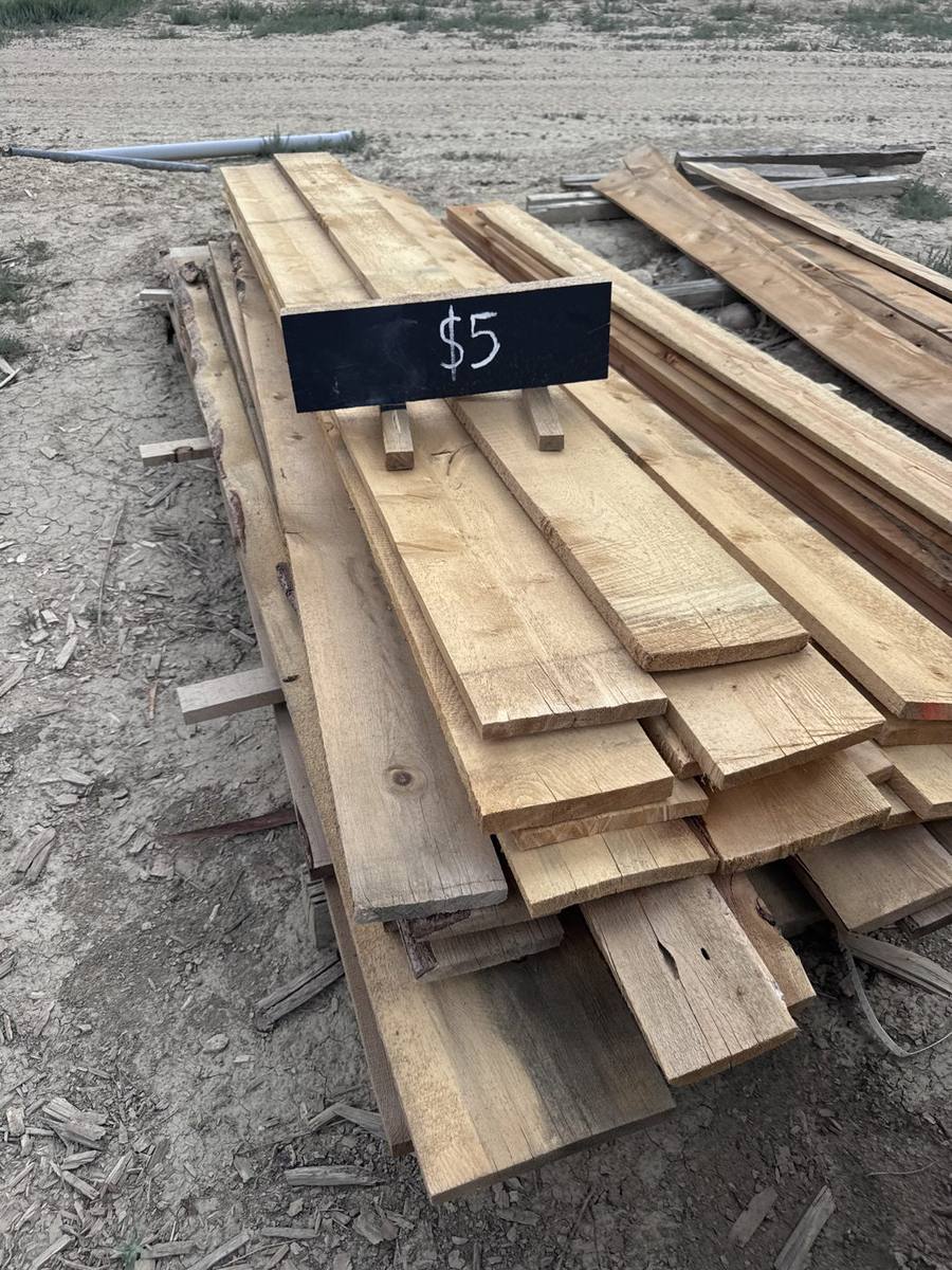 Surplus lumber pile with a $5 sign