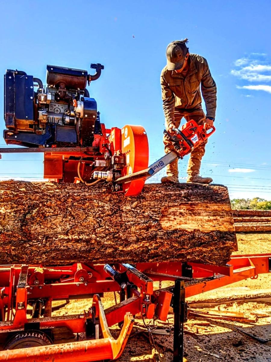 Justin trimming a big log on the sawmill