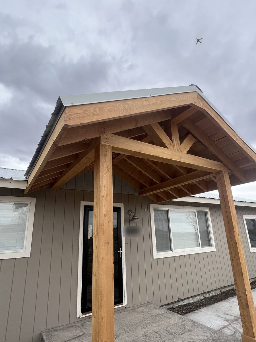 Timber-frame entry porch in rough-sawn fir