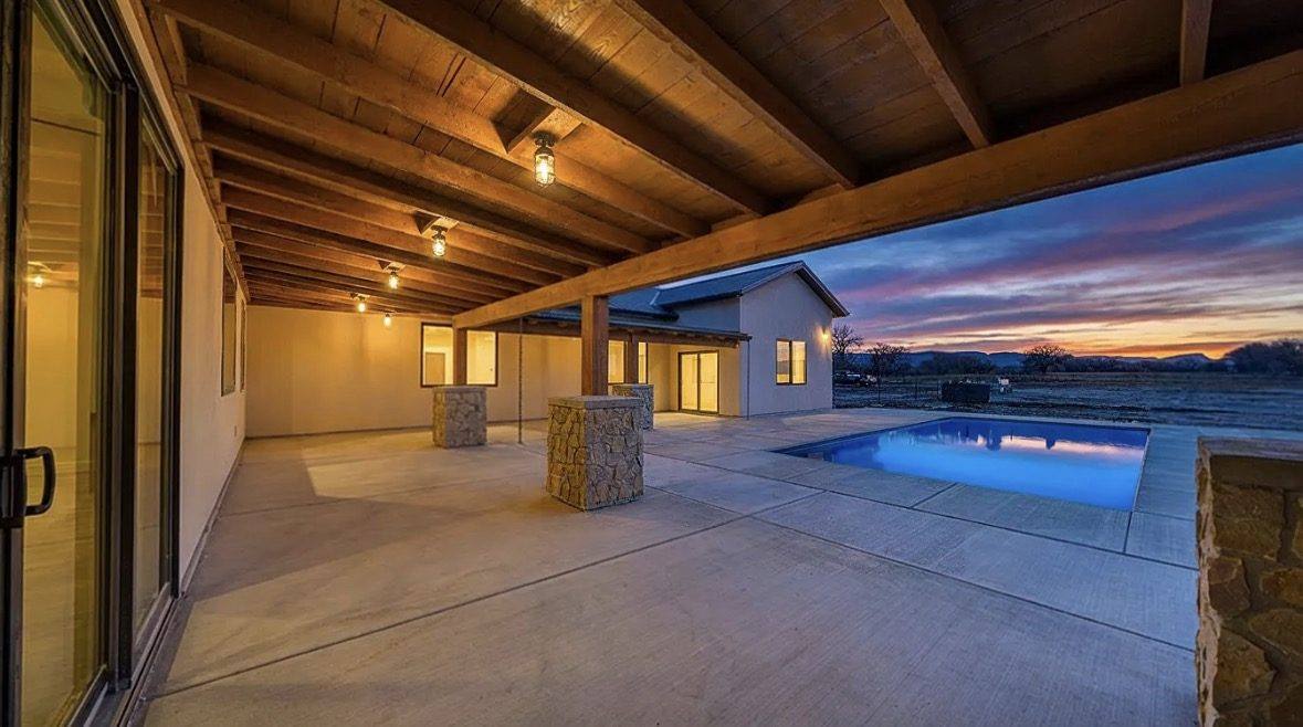 Custom home patio and pool at dusk, Doug fir timbers