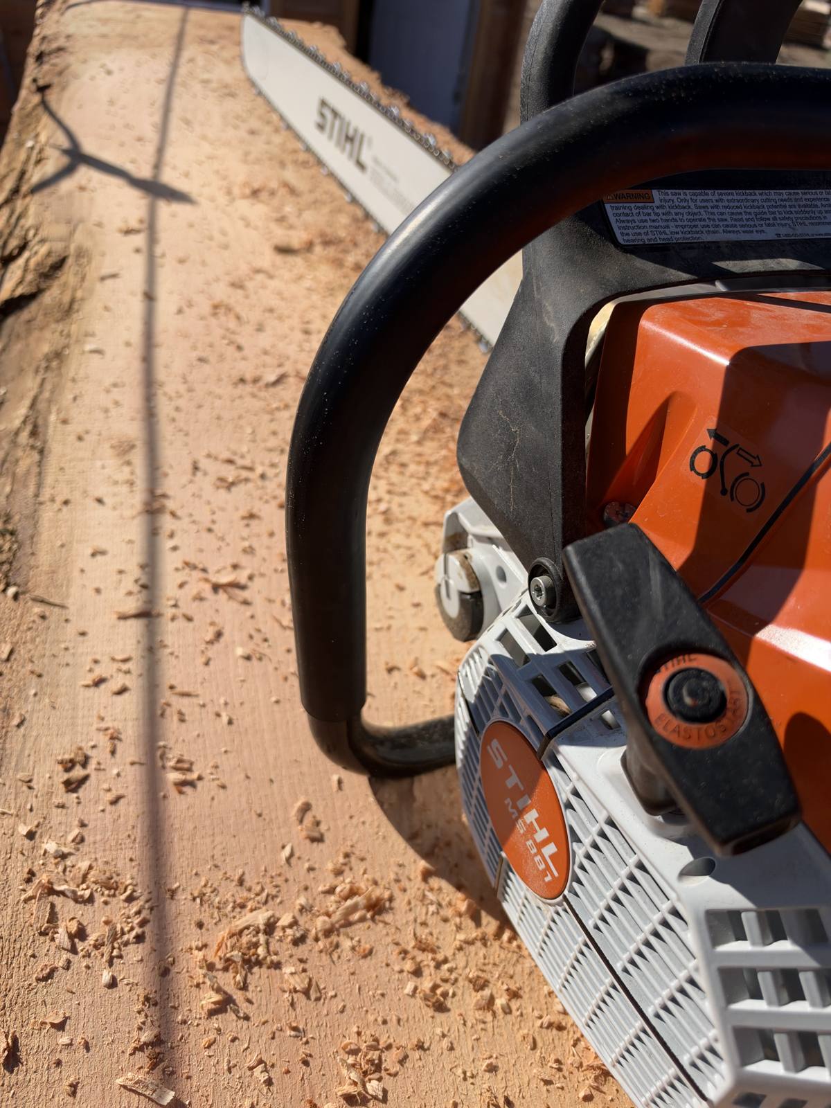 Stihl chainsaw resting on a fresh-cut slab