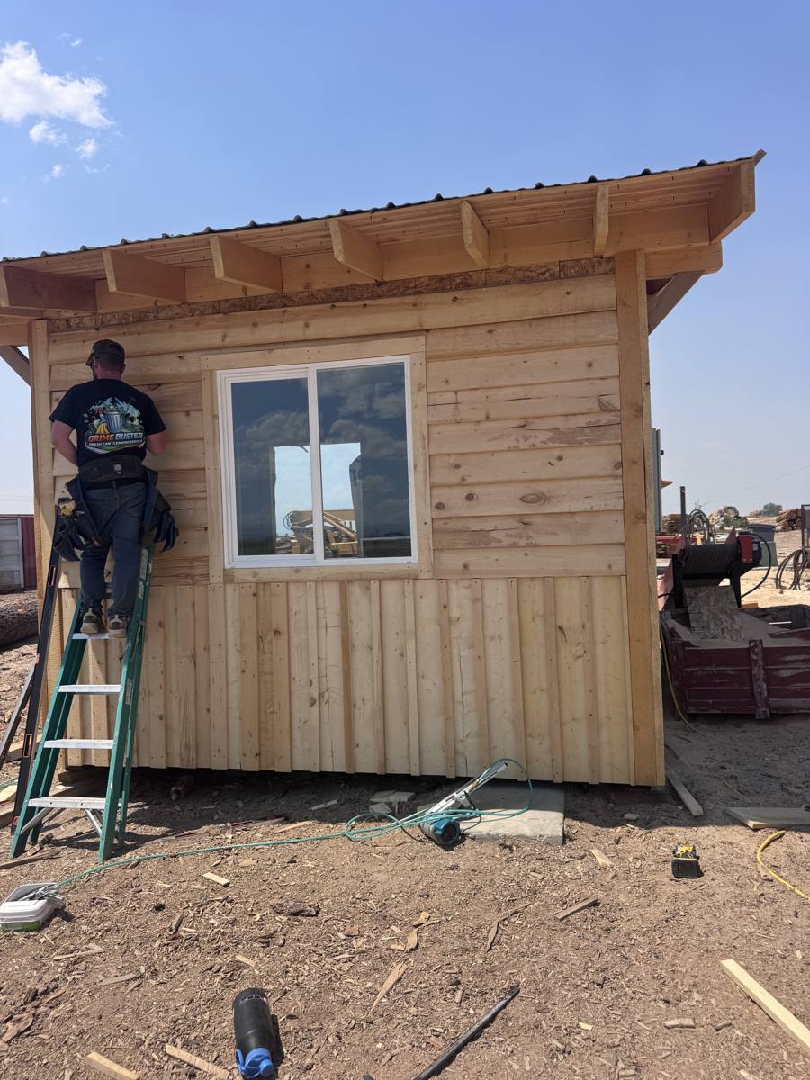 Rough sawn lap siding above and board and batten below on a small building at the JAMCo yard